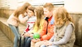 Children on a bench playing Chinese whispers