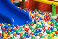 Modern children playground interior. Colored plastic balls pool with a blue hill. Selective focus Royalty Free Stock Photo