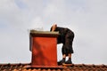 A modern chimney sweep checking out the chimney from the inside to see if it needs repair Royalty Free Stock Photo