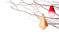 Modern Christmas ornaments hanging from frosty tree branches isolated on white Royalty Free Stock Photo