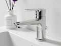 Modern chrome bathroom faucet with decorative vase Royalty Free Stock Photo