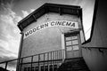 Modern cinema in garage, old building in medieval village, contrast Royalty Free Stock Photo