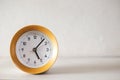 Modern circular alarm clock on white wood table background and tell time in morning or evening with copy space Royalty Free Stock Photo