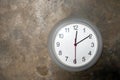 Modern circular clock hanging on old cement wall background Royalty Free Stock Photo