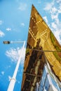 Modern city architecture, detail of glass building and lantern over blue sky and , reflection in glass building of city street Royalty Free Stock Photo