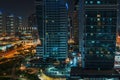 Modern city buildings at night. Typical Dubai high-rise constructions Royalty Free Stock Photo