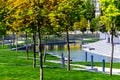 Modern city park with with different trees. Public relax place in big city