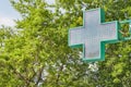 Signboard in the form of a cross at the entrance to the pharmacy Royalty Free Stock Photo