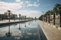 Modern City Promenade with Reflective Water Feature and Palm Trees Royalty Free Stock Photo