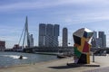 Modern city skyline with highrise skyscrapper and river. Public art and Erasmus Bridge