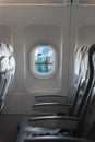 Modern city skyline through window on a commercial airliner airc