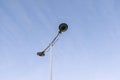 Modern city street lamp in the center of the photograph with the blue sky clear in the background Royalty Free Stock Photo