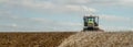 Modern claas tractor cultivating field Royalty Free Stock Photo