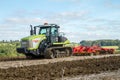 Modern claas tractor cultivating field Royalty Free Stock Photo