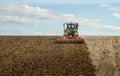 Modern claas tractor cultivating field