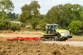 Modern claas tractor cultivating field