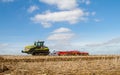 Modern claas tractor cultivating field