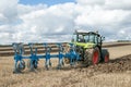 Modern claas tractor pulling a plough Royalty Free Stock Photo