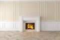 Modern classic beige interior with fireplace, wall panels, wooden floor. Royalty Free Stock Photo