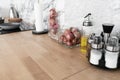 Modern classic kitchen interior with kitchen appliances and raw ingredients on wood top with marble wall in the background /