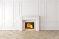 Modern classic white interior with fireplace, wall panels, wooden floor.