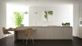 Modern clean contemporary white kitchen, island and wooden dining table with chairs, bamboo and potted plants, big window and Royalty Free Stock Photo