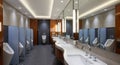 Modern Public Restroom with Urinals Sinks and Mirrors Royalty Free Stock Photo
