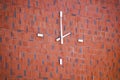 Modern clock on the brick building wall. Royalty Free Stock Photo