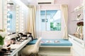 Modern closet room with make-up vanity table, mirror and cosmetics product in flat style house. Royalty Free Stock Photo