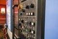 Modern CNC machining center with control panel on foreground. Close up view. Selective focus. Royalty Free Stock Photo
