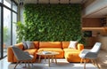 Modern co-working space with green vertical living wall. Tranquil work environment with orange sofa, designer chairs, table, Royalty Free Stock Photo