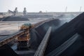 modern coal mine, with towering conveyor belts and large trucks transporting the mined fuel Royalty Free Stock Photo