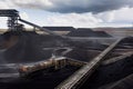 modern coal mine, with towering conveyor belts and large trucks transporting the mined fuel Royalty Free Stock Photo