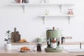 Modern coffee machine, jar of beans and croissant on counter in kitchen Royalty Free Stock Photo