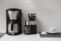 Modern coffee maker and grinder on counter in kitchen Royalty Free Stock Photo