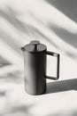 Modern coffee press design on a solid surface in natural light with soft shadows Royalty Free Stock Photo