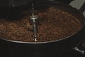 Modern coffee roaster machine with beans indoors, closeup Royalty Free Stock Photo