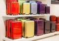 Modern colorful metallic luggage bags stacked on sale in shopping mall