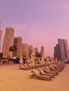 Modern with colorful sunbeds beach on light background. Urban background. Beautiful sunset. Royalty Free Stock Photo