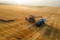 Modern combine harvester efficiently loading a tractor trailer Royalty Free Stock Photo