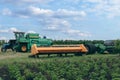 Modern combine harvester, tractor and plough in agricultural field