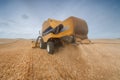 Modern combine harvester on a wheat field harvest. Royalty Free Stock Photo