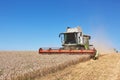 A modern combine harvester working a wheat field Royalty Free Stock Photo