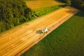 A modern combine harvester working a wheat field, aerial view Royalty Free Stock Photo