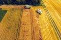 A modern combine harvester working a wheat field, aerial view Royalty Free Stock Photo