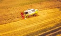 A modern combine harvester working a wheat field, aerial view Royalty Free Stock Photo