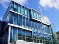 Modern Commercial Building, Clouds and Blue Sky Reflected in Glass Panels