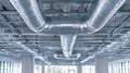 Modern commercial building interior showing extensive shiny silver metallic ductwork and ventilation system installed beneath Royalty Free Stock Photo