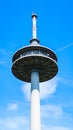 Modern communication tower with antennas under bright blue sky viewed from below. Royalty Free Stock Photo