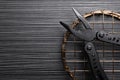 Modern compact portable multitool on black wooden table, top view. Space for text Royalty Free Stock Photo